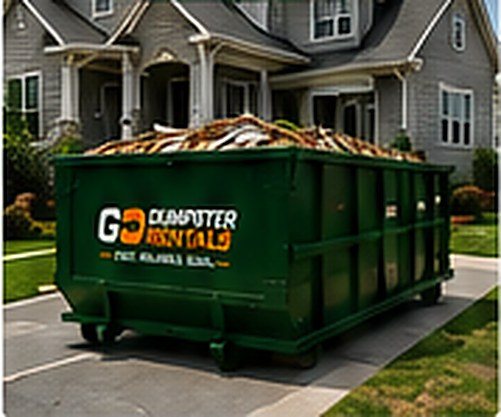 15 yard dumpster on a driveway outside a two-storey house